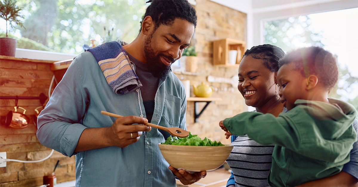 Man stiring a bowl of food for his family