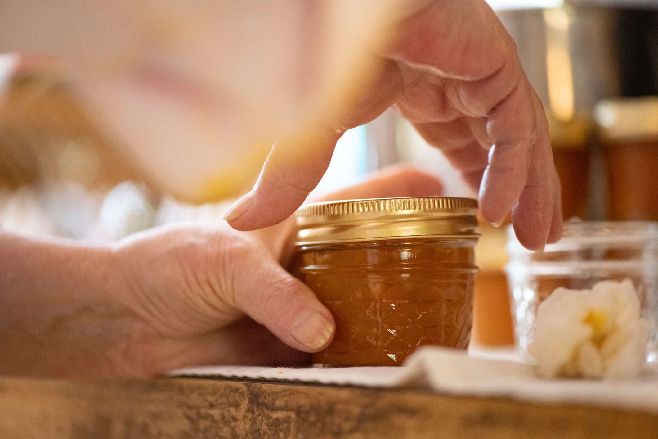 Hand gripping a jar